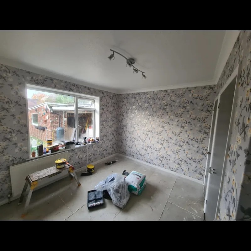 Room mid-redecoration with new wallpaper being fitted